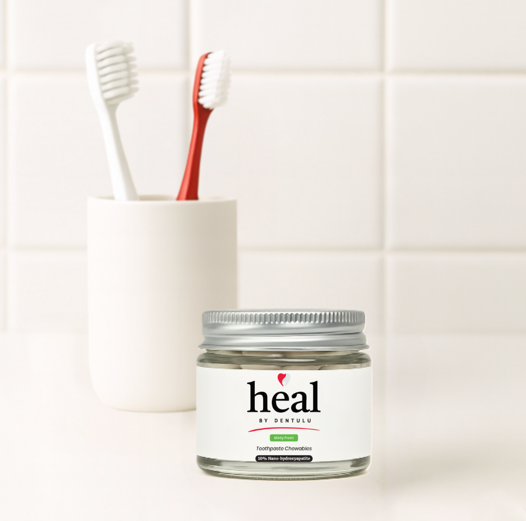 Jar of 'heal by Dentu' product with toothbrushes in the background